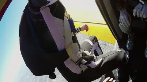 Two men jumping with a parachute over California Stock Footage 66538684