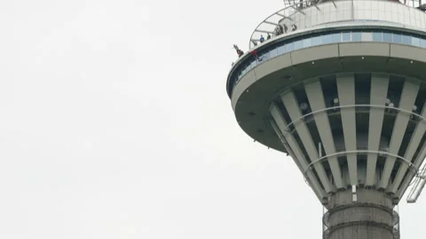 Two men jumping off the TV tower during a BASE jump in Estonia Stock Footage 157312569