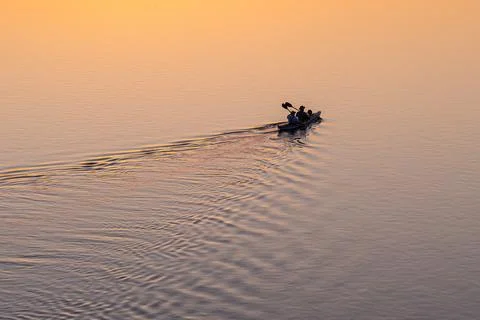 Two men kayaking on river at sunset, enjoying outdoor adventure, water spor.. Stock Photos