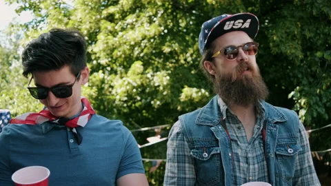 Two men laughing and chatting at independence day party Video stock 133603395