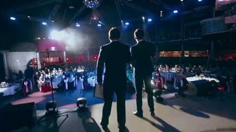The two men leading go on stage, start to exercise. 스톡 동영상 62751966