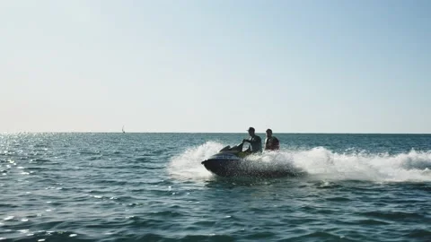 Two men in life jackets are skiing on the water scooter. tourists are moving on Stock Footage 201344973