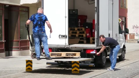 Two Men loading a Food Delivery Truck on a Street - Poland Europe Stock-Footage 153916134