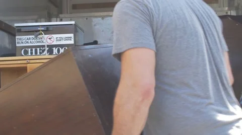Two men loading old tv into moving truck Stock Footage 56805443