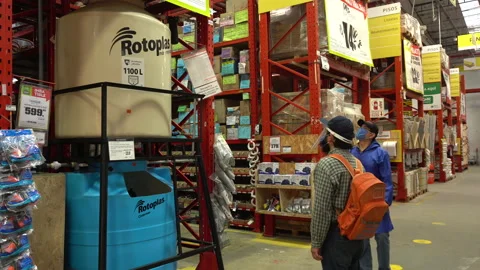  two men looking at a water tanks to buy in a wholesale store.  Vidéo 140320896