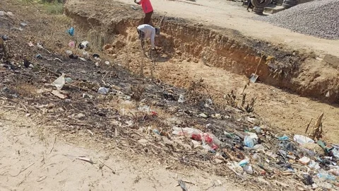 Two Men Manually Digging Water Passage By Roadside Kano Nigeria Stock Footage 325959519