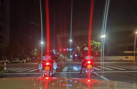 Two men on motorcycles at night Stock Photos