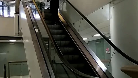 Two men on moving escalator up, mecanic, electric, Stock Footage 95232907