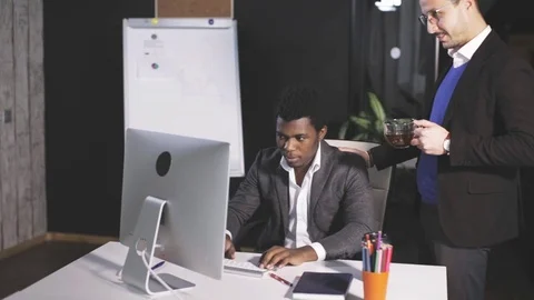 Two men in the office discussing the project in front of the computer Stock Footage 81010324