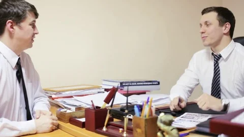 Two men in the office shaking hands Stock Footage 76992928