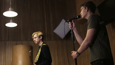 Two Men, One of Them is Singing to the Microphone Stock Footage 72221385