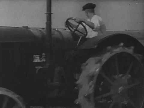 Two men operate a thresher in a wheat field Video stock 229003951