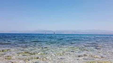 Two men on a paddle surf board known as SUP or Stand Up Paddle Stock Footage 122744328