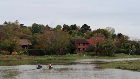 Two men paddling canoes on the river Blackwater estuary at high tide. Stock Footage 145901678