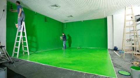 The two men paint the wall and floor in the green. Time lapse. Wide angle Vídeos de archivo 61440646