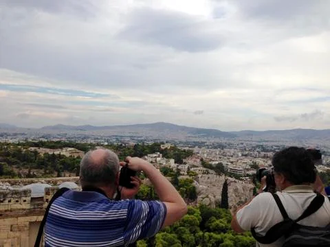 Two Men Paparazzi back turned with photocamera shoot landscape in Athens, Greece Stock Photos