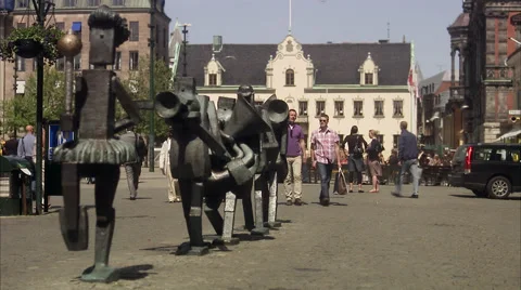 Two men passing by a statue in Malmo, Skane, Sweden. Stock Footage 51848611