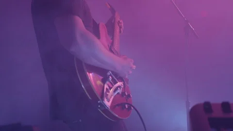 Two men performing on guitar and keyboard on stage with flashing lights Stock Footage 127144064