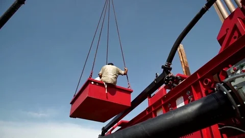 Two men on a platform suspended from a crane. Stock Footage 71306503