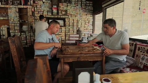 Two men play backgammon in a local cafe. Eastern atmosphere. Stock Footage 123526337