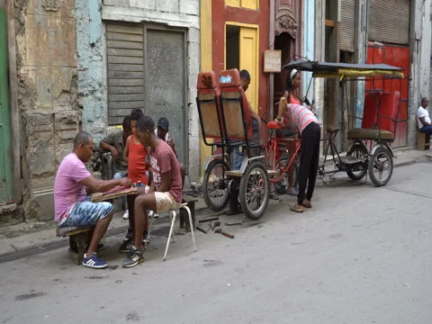 Two men play checkers on the central street of Havana Stock Footage 71141744