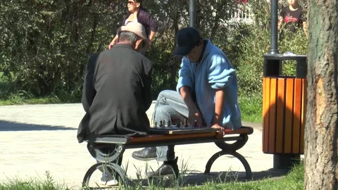 Two men play chess on a central street in Ulaanbaatar, Mongolia. Stock Footage 303510223