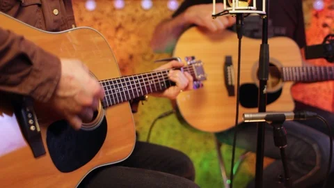 Two men playing acoustic guitars in cozy interior. Stock Footage 124554727