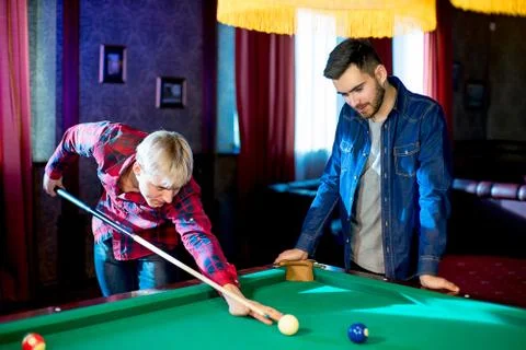 Two men playing billiard Stock Photos