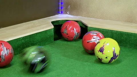 Two men playing billiards, hitting balls into holes on a floor billiard table 4K Stock-Footage 109273621