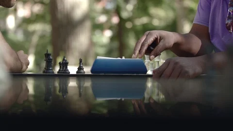 Two men playing chess on a chessboard with a timer during competition Stock-Footage 93519136