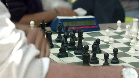 Two men playing a competitive game of chess with a timer Stock-Footage 93519085
