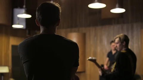 Two Men Playing Electric Guitars Seen From the Side Stock Footage 72204723