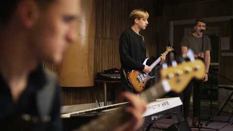 Two Men Playing Electric Guitars and a Vocalist Singing Stock Footage 72211685