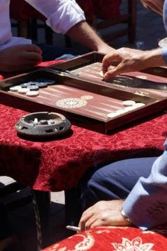 Two men playing a game of backgammon Stock Photos