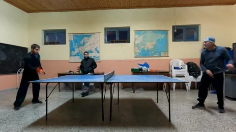 Two Men Playing Intense Table Tennis Ping Pong Match in Indoor Sports Hall Stock Footage 328337120