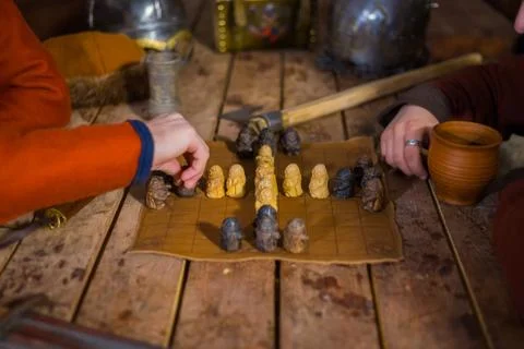 Two men playing popular strategy board game - tafl Stock Photos