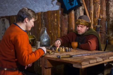 Two men playing popular strategy board game - tafl Stock Photos
