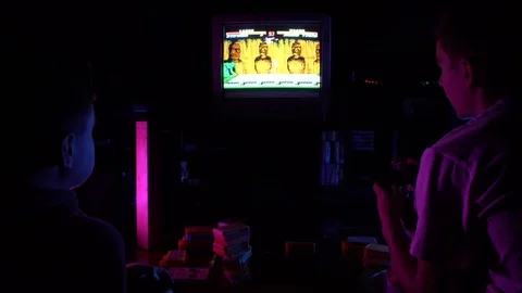 Two men playing retro console at the night Video stock 126094266