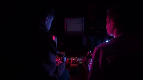 Two men playing retro console Stock Footage 126094443