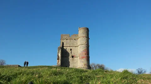 Two men point to beautiful views next to Castle (dolly in &amp; out) Stock Footage 34343175