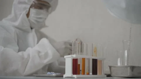 Two men in ppe suit working with scientific test tube in the lab Stock Footage 156683664