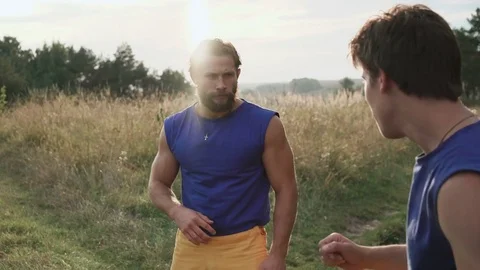 Two men practising free fight on the nature. 4K Video stock 80528812