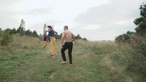 Two men practising free fight on the nature. 4K Video stock 80528915