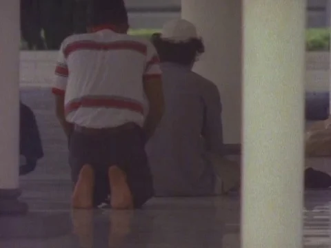 Two men praying in a Jamek Mosque Video stock 79881379