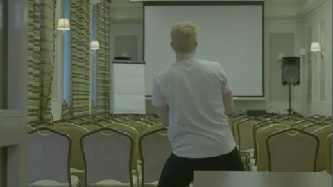 Two Men Preparing a Conference Room for a Presentation Stock Footage 341863611