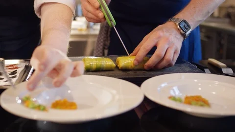 Two men preparing a delicious fish meal Stockbeeldmateriaal 118975646