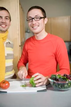 Two men preparing food in the kitchen Stock Photos