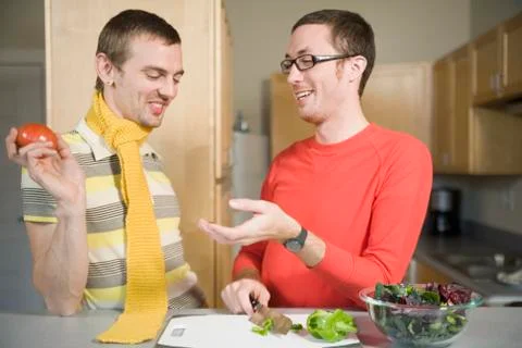 Two men preparing food in kitchen Stock Photos