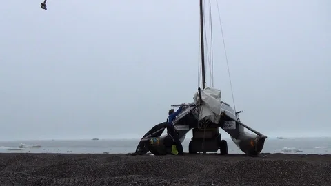 Two men preparing their catamaran on an Arctic beach Video stock 104849528