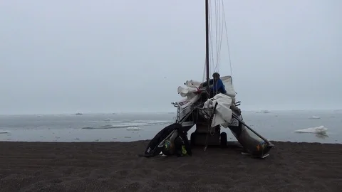 Two men preparing their catamaran on an Arctic beach Video stock 104849532